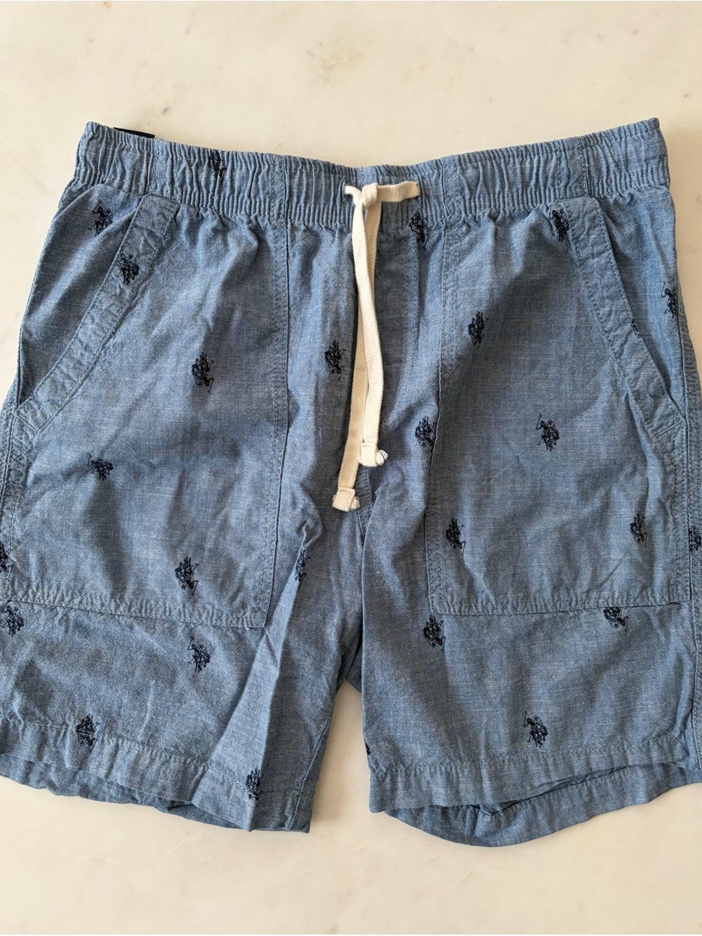 U.S. Polo Assn. Navy Label on Light Blue Cotton Garment